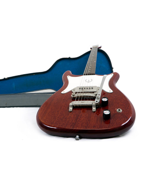 A vintage 1965 Epiphone Coronet guitar with its case, displayed on a pristine white surface, highlighting its timeless style.