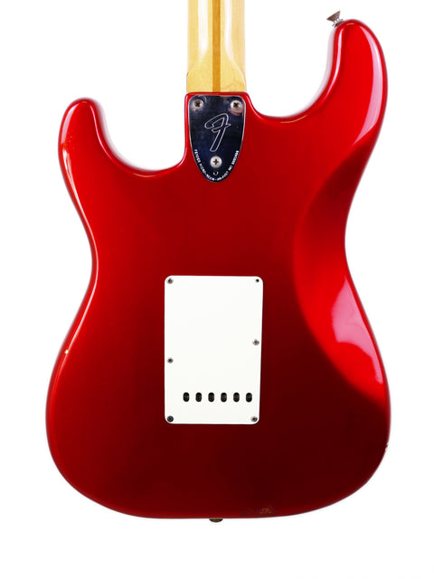 A vintage 1979 red Fender Stratocaster guitar featuring a striking white pickguard, highlighting its iconic style.