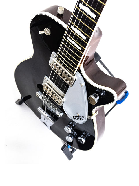 A vintage 1989 Gretsch Duo Jet 6128 guitar in black, featuring a striking white pickguard, highlighting its elegant style.