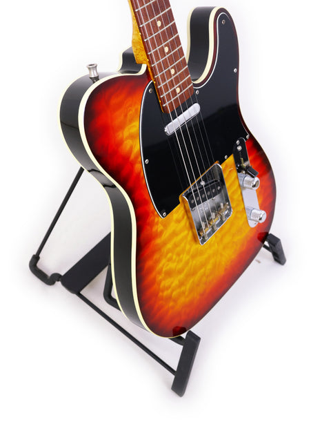 A vintage 1998 Fender Custom Shop 50s Telecaster guitar with a sunburst finish, beautifully displayed on a stand.