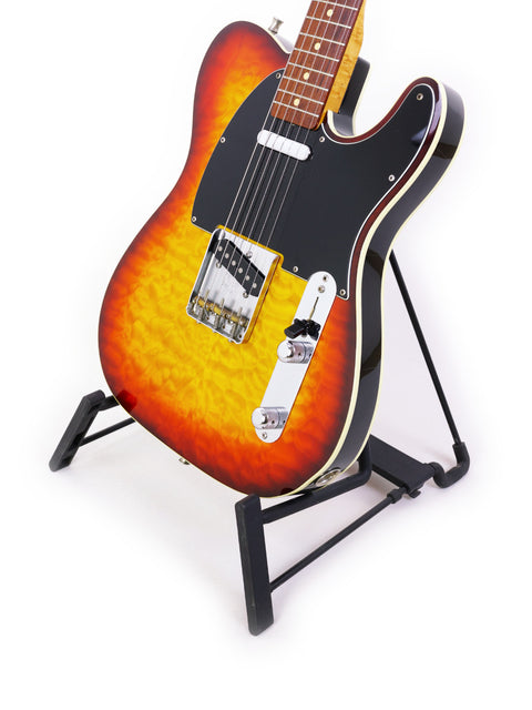 A vintage 1998 Fender Custom Shop 50s Telecaster guitar with a sunburst finish elegantly positioned on a stand.