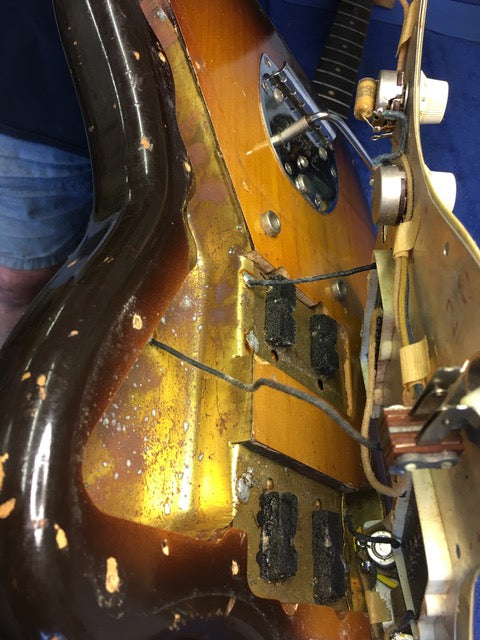 A vintage Fender Jazzmaster from 1960 undergoing reassembly after repairs, emphasizing its iconic shape and historical significance.