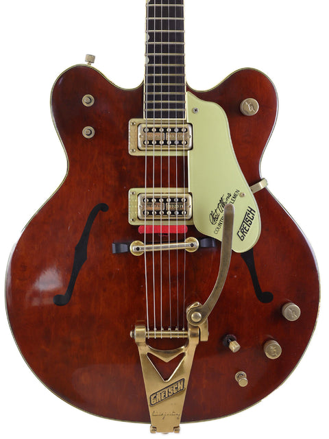 A vintage Gretsch G-60S guitar in brown, showcasing its classic design and craftsmanship from the 1967 Chet Atkins model.