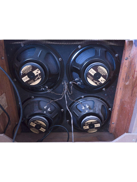 A vintage wooden box featuring four speakers, part of the iconic 1961 Fender 6G12A Concert Amp.