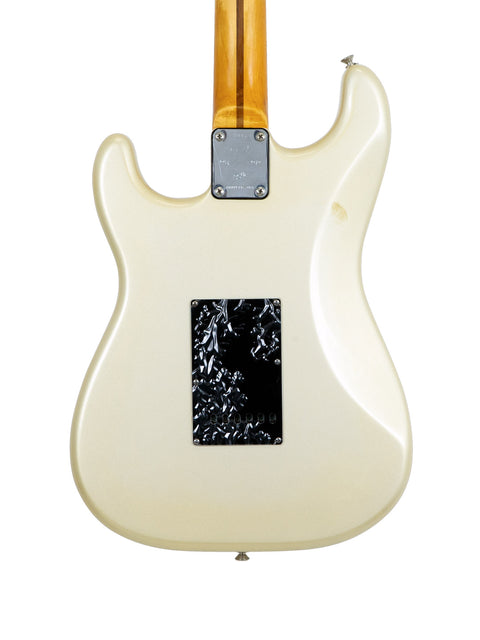 A white 1979 Fender Stratocaster guitar with a black pickguard, celebrating its 25th anniversary with a timeless look.