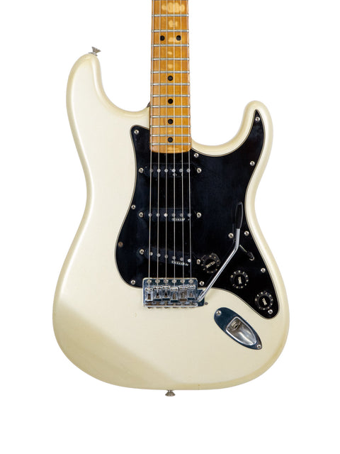 A white Fender 25th Anniversary Stratocaster electric guitar featuring a sleek black pickguard.
