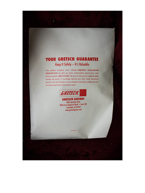 A white envelope adorned with red text, likely connected to the 2011 Gretsch Chet Atkins G6120 from Japan.