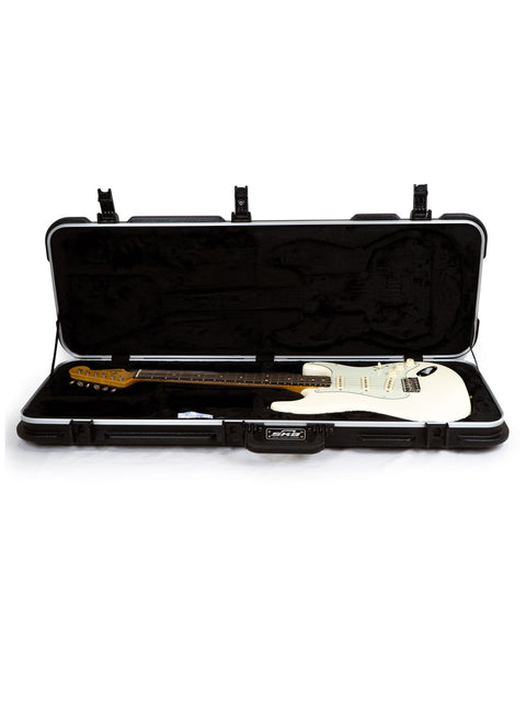 A white guitar, a Fender '60s Strat Partscaster, is nestled in a case, showcasing its elegant Olympic White design.
