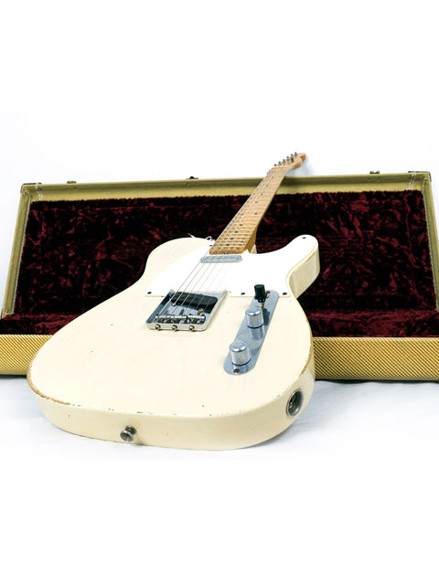 A white guitar with a wooden body, the Fender Custom Shop 55 Tele, securely placed in its case, USA, 2006.