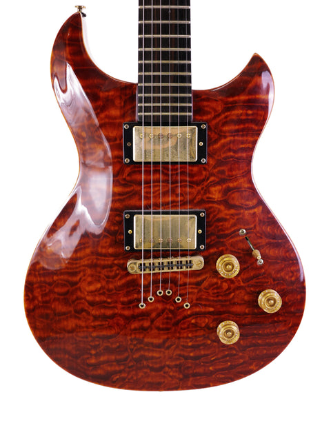 A wooden-bodied guitar with a gold tone, labeled Jarrett Forza, Serial #00001, made in the USA in 2007.