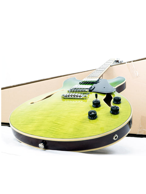 An Ibanez Artcore AS73 FM electric guitar in striking green, securely placed in a wooden case, highlighting its semi-hollow body.