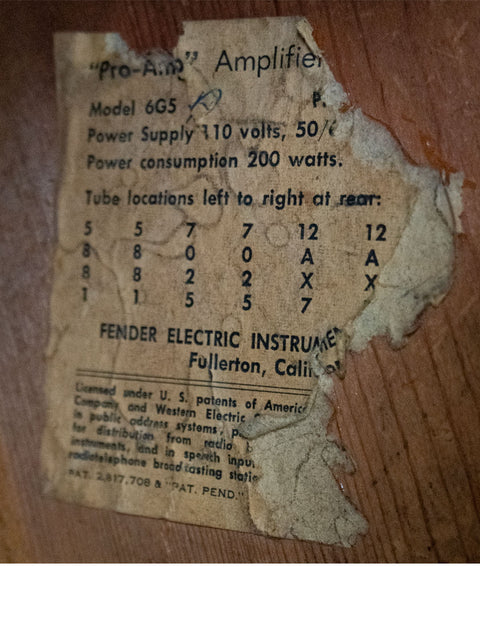 An aged piece of paper featuring a label, referencing the Vintage Fender Brownface Pro Amp from the USA, 1961.