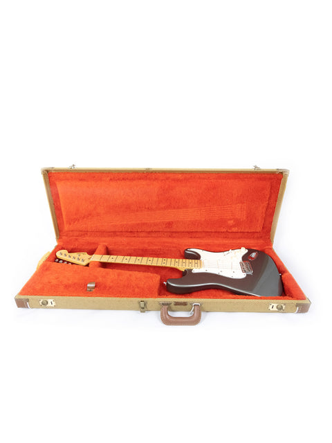 An iconic Fender Stratocaster electric guitar, part of the Eric Clapton Signature Series, securely stored in a case.