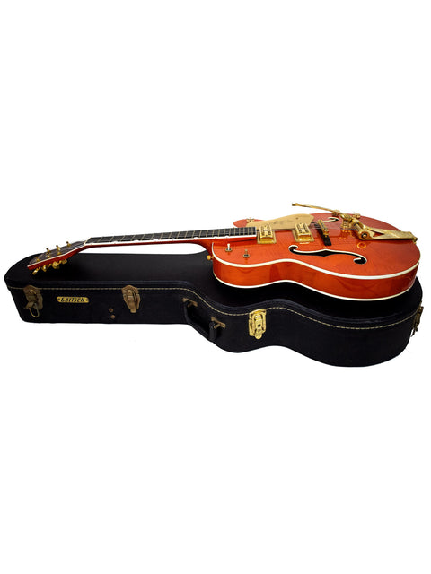 An orange-bodied Gretsch Chet Atkins G6120 guitar case with a black exterior, made in Japan in 2011.