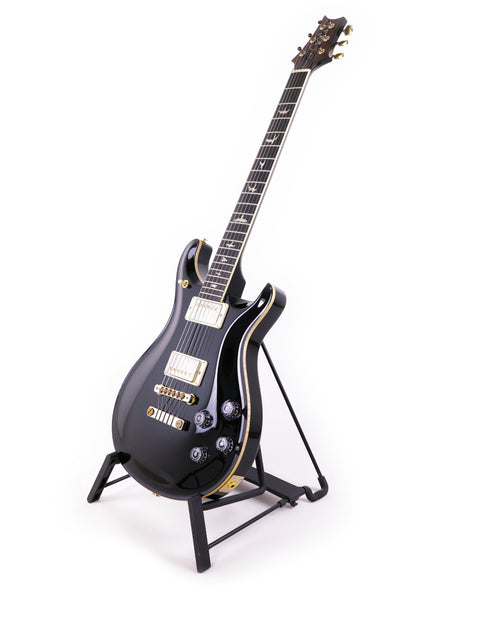 Black PRS McCarty 594 electric guitar from 2016 resting on a stand.