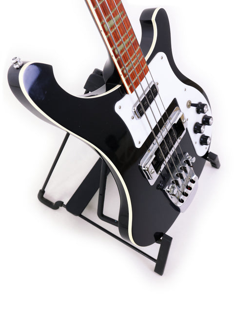 Black Rickenbacker 4003 Jetglo bass guitar on a stand against a clean white background.