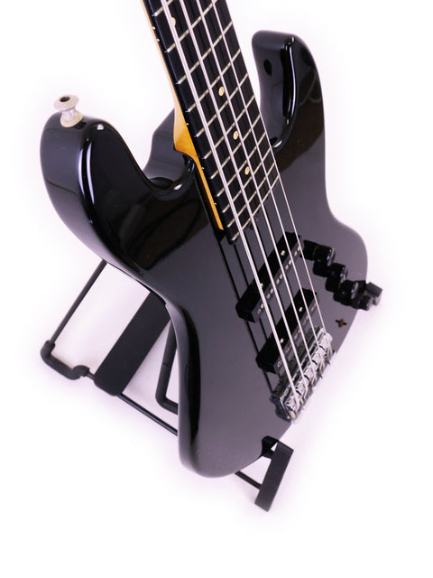 Black Sadowsky NYC Jazz Bass 5 String guitar positioned on a stand, set against a plain white background.