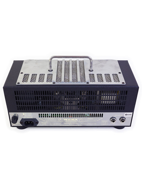 Black and white Mesa Boogie TA-15 amplifier with a sleek metal cover, showcasing its vintage design from 2010.