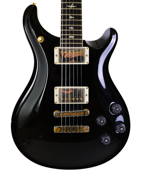 Black electric guitar with a gold pickguard, PRS McCarty 594 model from the USA, year 2016.