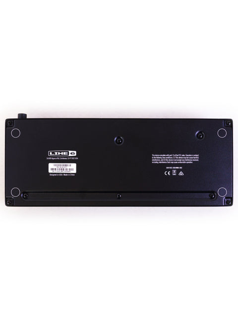 Black laptop battery's rear side, showcasing the Line 6 HX STOMP XL Guitar Processor, model year 2022.