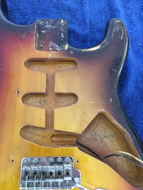 Broken neck and bridge on a vintage 1958 Fender Stratocaster, emphasizing its classic design and wear.