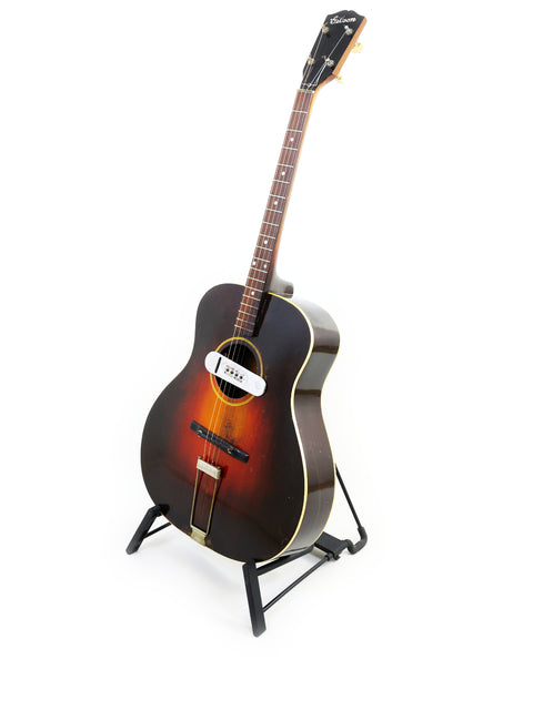 Classic 1934 Gibson TG50 Tenor Guitar displayed on a stand, perfect for collectors and music enthusiasts, set against white.