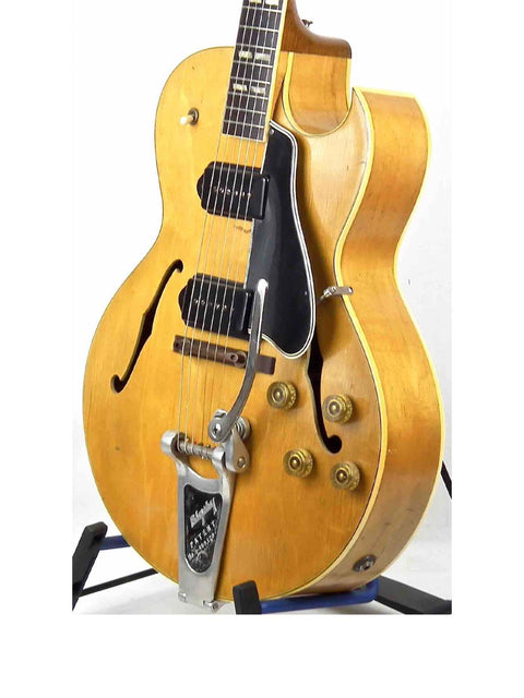Classic 1953 Gibson ES 175 DN guitar in yellow, accented by a black pick guard, representing vintage elegance.