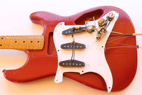 Classic 1957 Fender Stratocaster in Dakota Red, adorned with a white pickguard, highlighting its iconic vintage style.