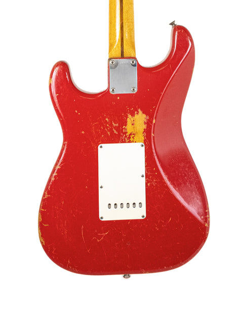 Classic 1957 Fender Stratocaster in Dakota Red with a white pickguard, highlighting its iconic vintage style and American heritage.