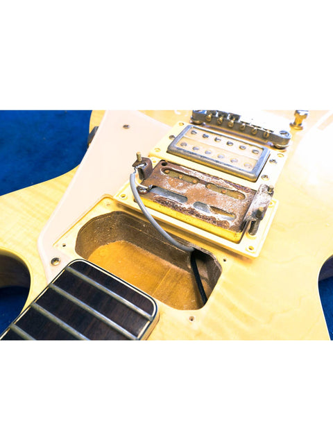 Close-up image of a Univox Gimmie U-1988 guitar, featuring the pickup and cover, crafted in Japan, 1974-75.