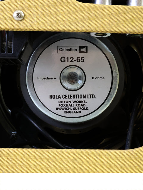 Close-up image of a yellow speaker on the Fender EC Tremolux Combo Amplifier, emphasizing its striking appearance and craftsmanship.