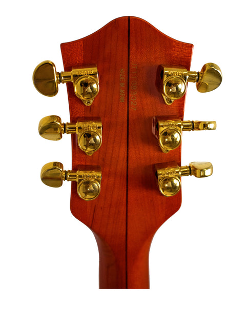 Close-up image of the headstock of a 2011 Gretsch Chet Atkins G6120, emphasizing its unique design and quality.