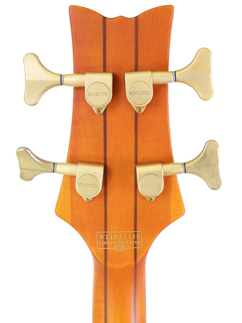 Close-up image of the neck of a Schecter Stiletto Studio 4 bass guitar, emphasizing its elegant design and South Korean craftsmanship.