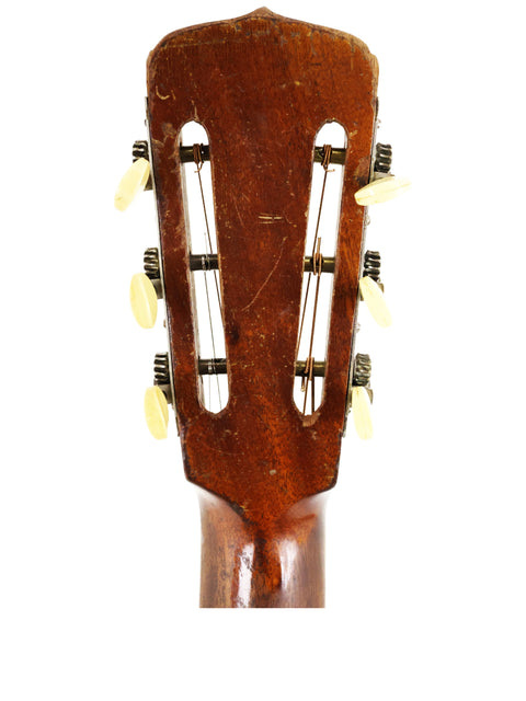 Close-up of a 1930's Gibson D-18B acoustic guitar, highlighting its elegant curves and rich wood finish.