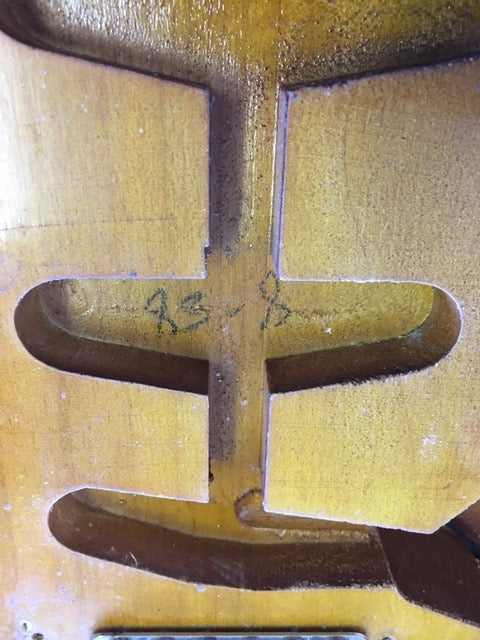 Close-up of a 1958 USA Fender Stratocaster, featuring a stunning wooden back design.