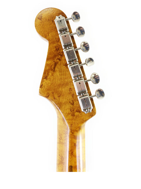 Close-up of a Fender AVRI ‘56 Stratocaster headstock, displaying its wooden body and finely crafted tuning hardware.