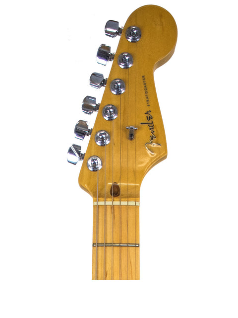 Close-up of a Fender American Deluxe Stratocaster guitar head against a clean white background, showcasing its design and details.