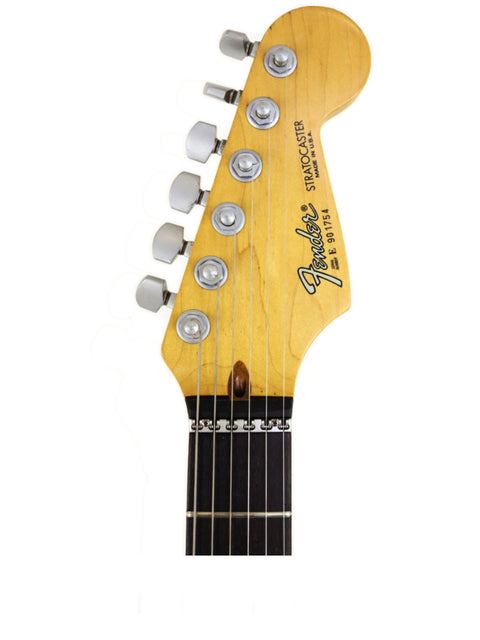 Close-up of a Fender Strat Plus Deluxe electric guitar neck, showcasing its intricate details and craftsmanship from 1989.