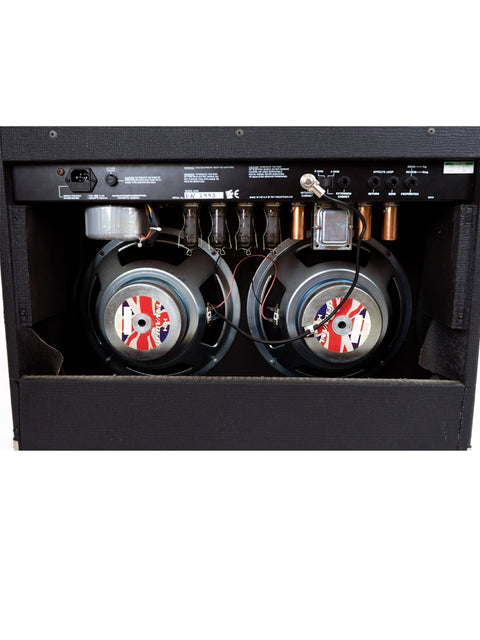 Close-up of a Laney VC 30-212 Class A amplifier alongside two speakers, capturing the essence of audio equipment design.