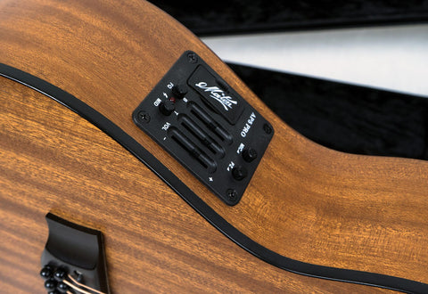 Close-up of a Maton Mahogany Mini12 String EMM-12 acoustic guitar resting in a black case, showcasing its rich wood grain.