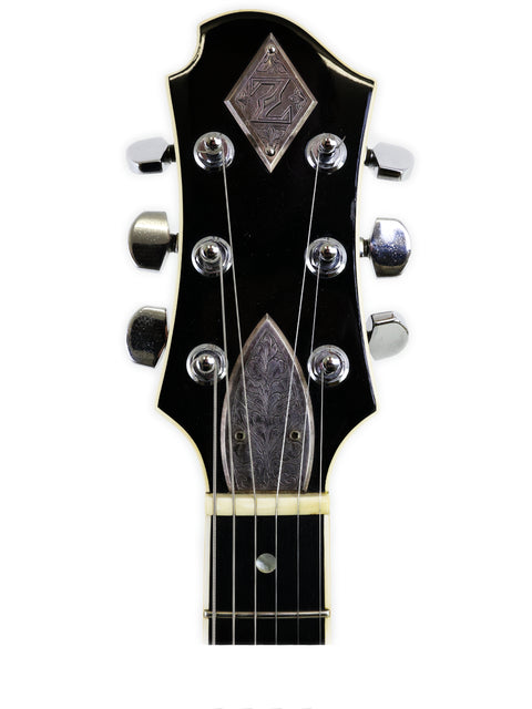 Close-up of a sleek black guitar headstock from the Greco Zemaitis GZ-2600IF, showcasing its premium craftsmanship from Japan 2004.