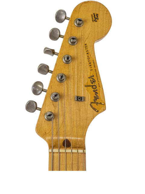 Close-up of the headstock from a 1958 USA Fender Stratocaster, highlighting its vintage features and tuning pegs.
