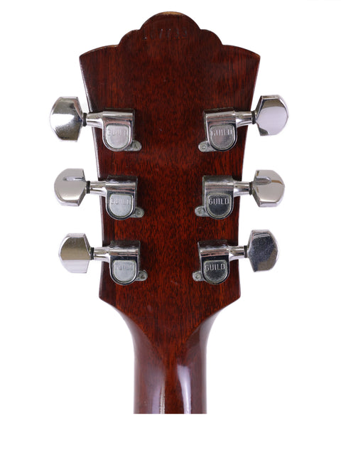 Close-up of the headstock from a 1974 Guild D-50 Bluegrass Special acoustic guitar with four tuning knobs.