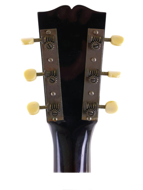 Close-up of the headstock from a 2009 Beau Hannam Parlour guitar, showcasing four knobs for tuning and sound control.