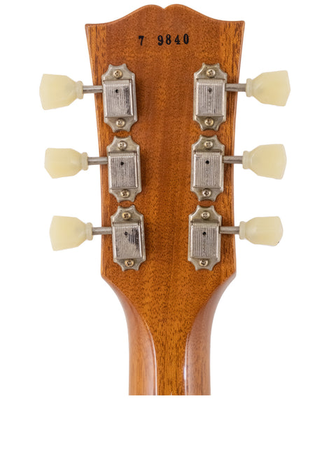 Close-up of the headstock from a Gibson Custom Shop LPR-7 1957 Les Paul Goldtop Reissue, showcasing four knobs.