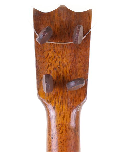 Close-up of the headstock of a 1917 Manuel Nunes Style #3 ukulele, featuring rich wood textures and elegant design.