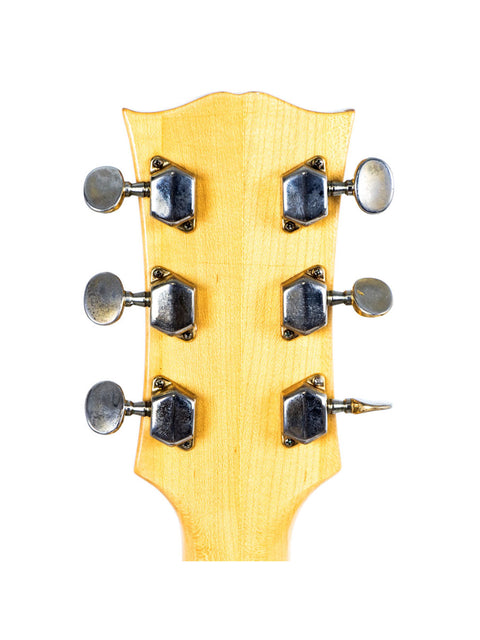 Close-up of the headstock of a Univox Gimmie U-1988 electric guitar, showcasing its vintage design from Japan, 1974-75.