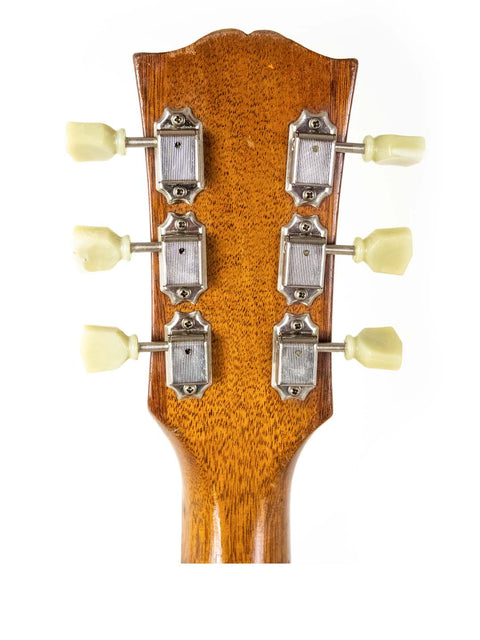 Close-up of the headstock on a 1953 Gibson ES 175 DN acoustic guitar, showcasing four tuning knobs.
