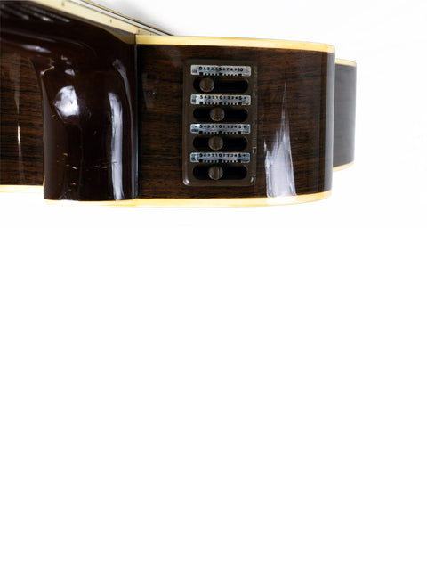 Close-up shot of a Takamine EF 360SC guitar, made in Japan in 1988, featuring a stunning wooden body.