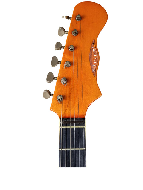 Close-up shot of a Warmoth Strat Partscaster electric guitar from 2012, focusing on its stunning wooden headstock.